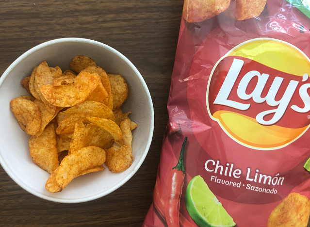 a bag of chile limon lays next to a bowl of chips