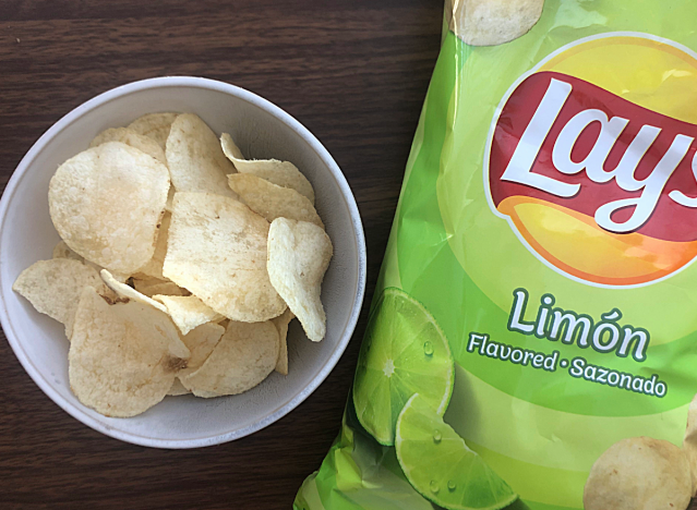 a bag of lays limon next to a bowl of chips