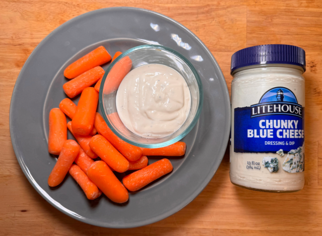 a jar of litehouse blue cheese next to a plate of carrots 