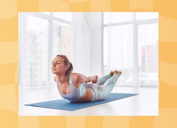 focused woman doing locust pose on yoga mat in bright room surrounded by windows