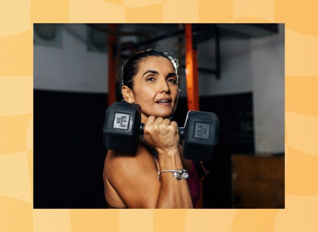 mature woman lifting weights at the gym