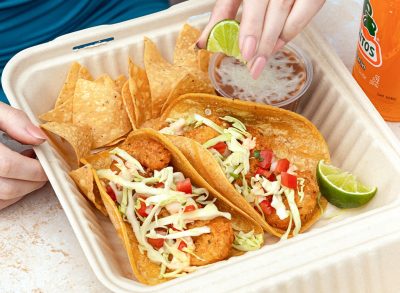 person squeezing lime on tacos from rubio's coastal grill