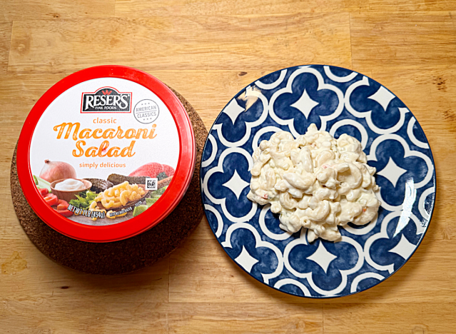 a container of reser's macaroni salad next to a plate of it 