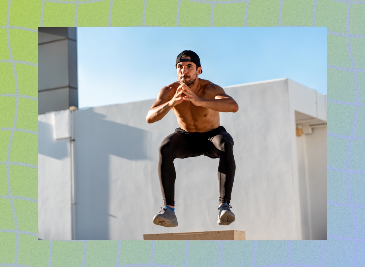 fit man doing squat jumps exercise outdoors