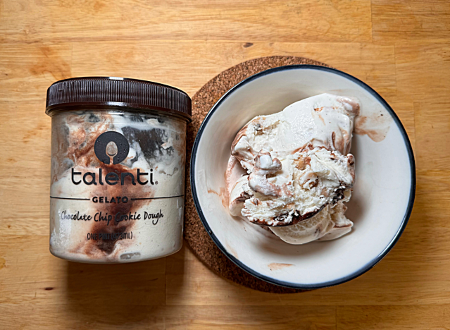 a container of talenti cookie dough ice cream next to a bowl of it 