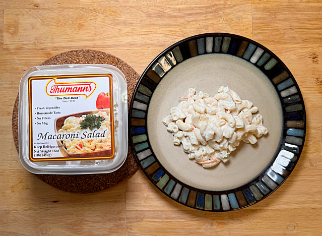 a container of thumanns macaroni salad next to a plate of it 