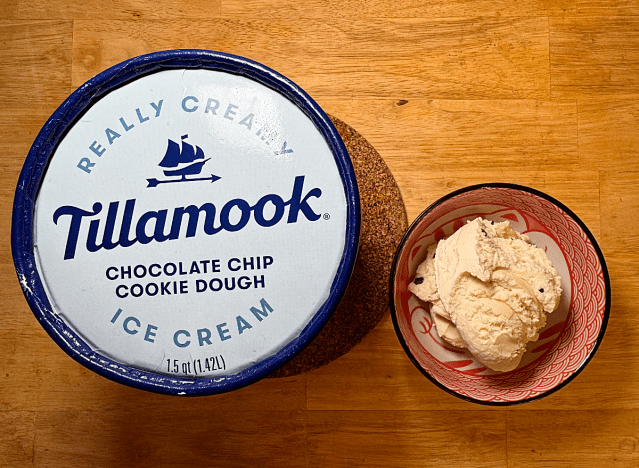 a container of tillamook cookie dough next to a bowl of it 