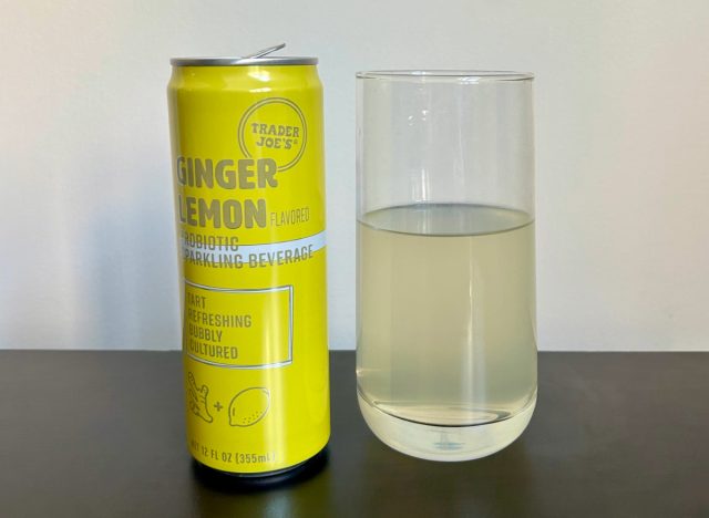 can of trader joe's ginger lemon probiotic sparkling beverage next to a glass of the drink