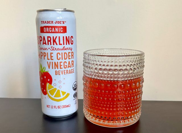 can of trader joe's organic sparkling lemon + strawberry apple cider vinegar beverage next to a glass of the drink