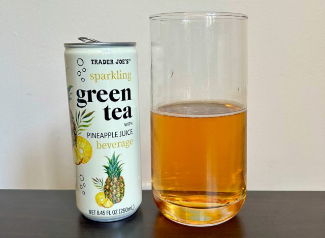 can of trader joe's sparkling green tea with pineapple juice next to a glass of the beverage