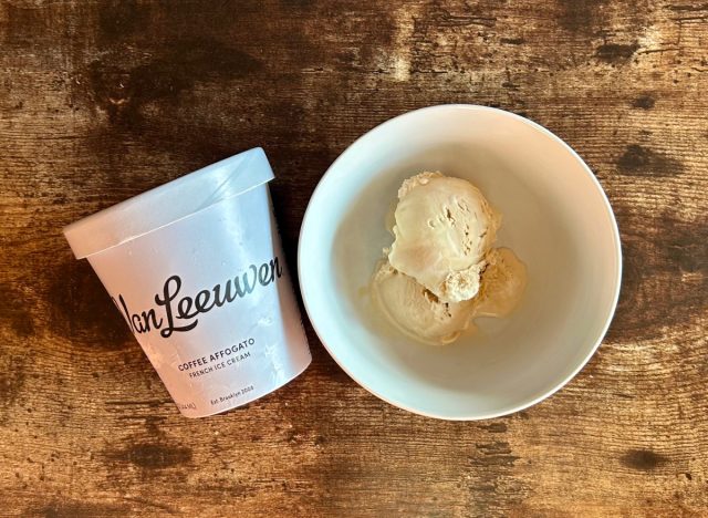 a pint of van leeuwen coffee affogato ice cream next to a bowl of the ice cream on a wooden table background