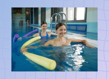 two women doing water aerobics class or water resistance walking with noodles in the pool