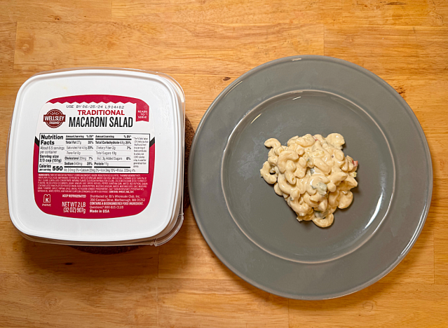 a container of wellsley farms macaroni salad with some macaroni salad on a plate 