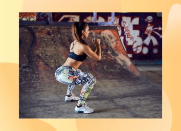 fit woman doing squats at skate park