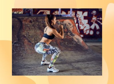 fit woman doing squats at skate park