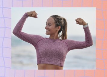 fitness woman flexing at the beach