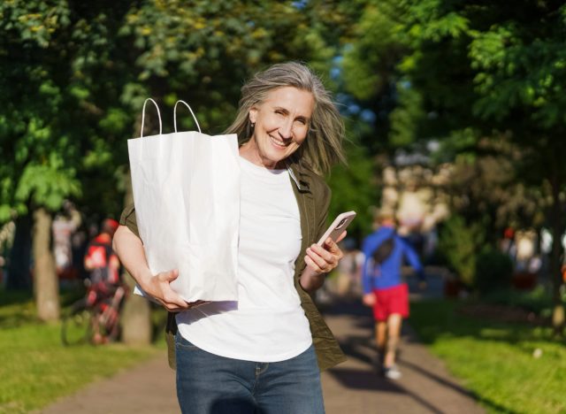 woman holding bag of groceries