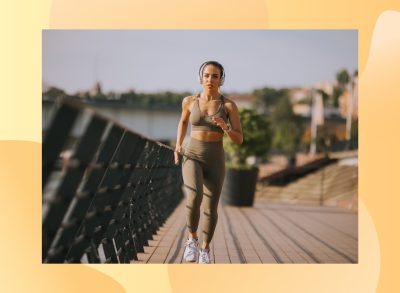 fit woman jogging on boardwalk