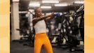 fit woman doing kettlebell swings at the gym