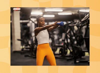 fit woman doing kettlebell swings at the gym