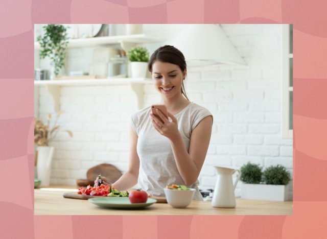 woman making healthy recipe, counting calories at home in bright kitchen