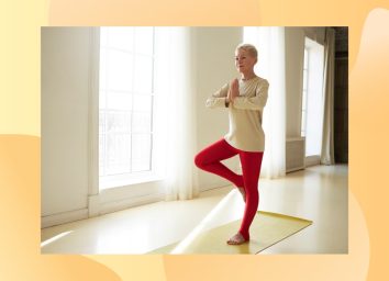 woman doing tress pose in yoga room