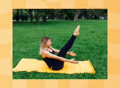 focused woman doing V-up exercise on yellow yoga mat on yawn