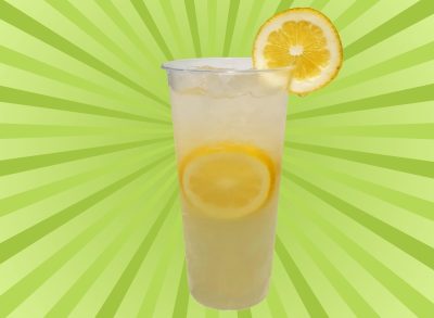 A tall plastic cup of lemonade set against a vibrant green background