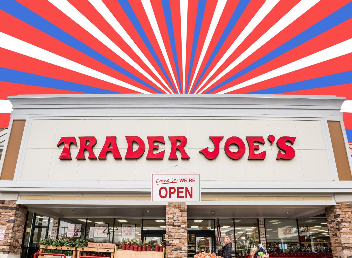 The storefront of a Trader Joe's supermarket set against a patriotic red, white and blue background.