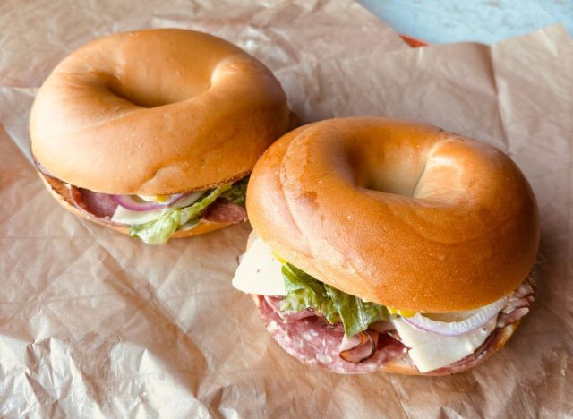 Two Panera Bread bagel sandwiches on a table