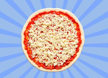 Pizza dough with tomato sauce and mozzarella set against a vibrant blue background.