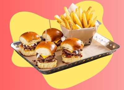 A platter of burger sliders and fries from Chili's set against a colorful background