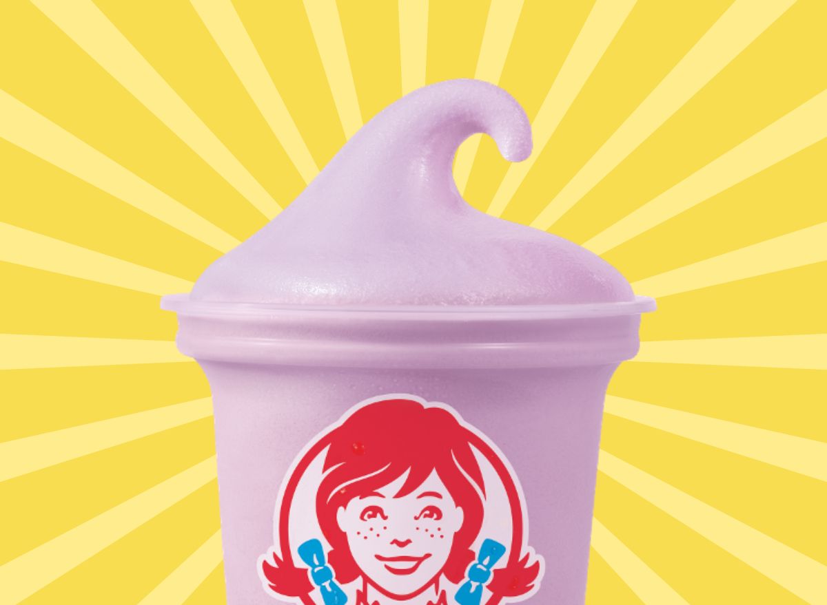 Wendy's new triple berry frosty set against a vibrant yellow background.