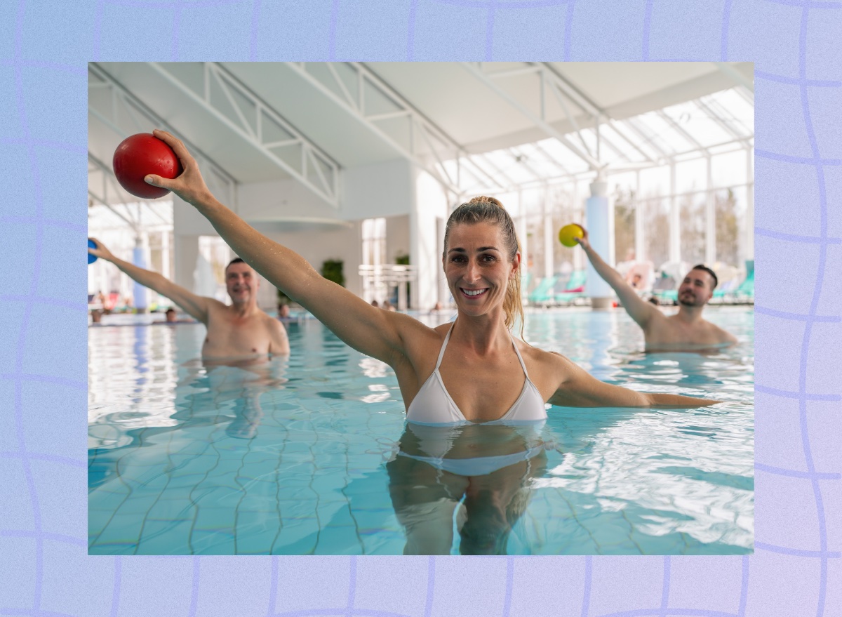 fit woman doing arm exercises in the pool during a group fitness class