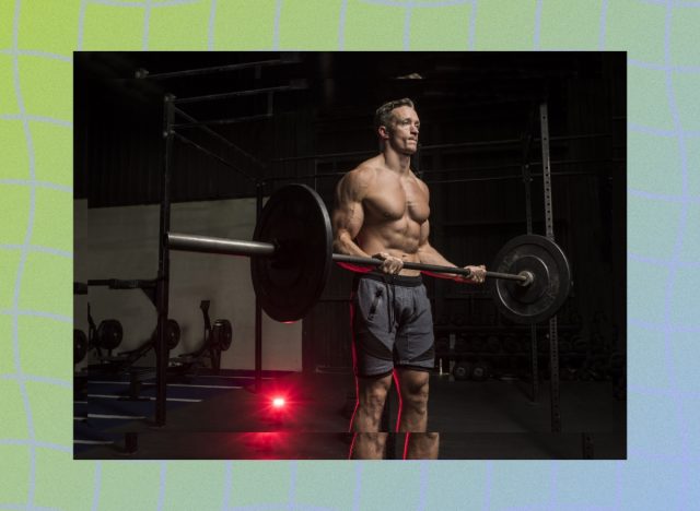 fit, muscular man doing barbell bicep curls in a dark gym setting