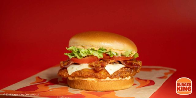 burger king's fiery royal crisy chicken sandwich on a red background
