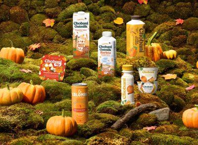 chobani pumpkin spice products in a field with pumpkins