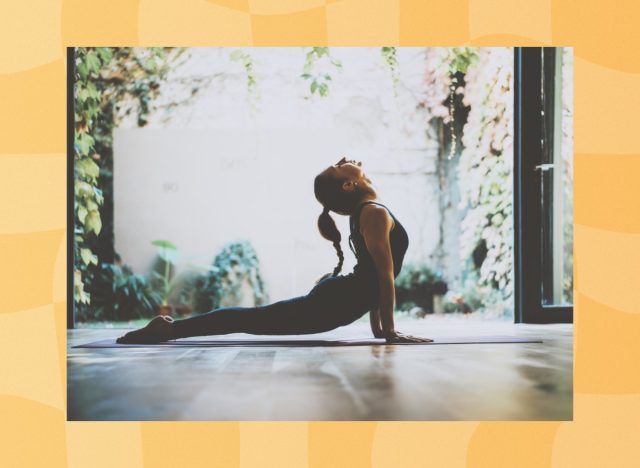 fit woman doing cobra pose in garden living space