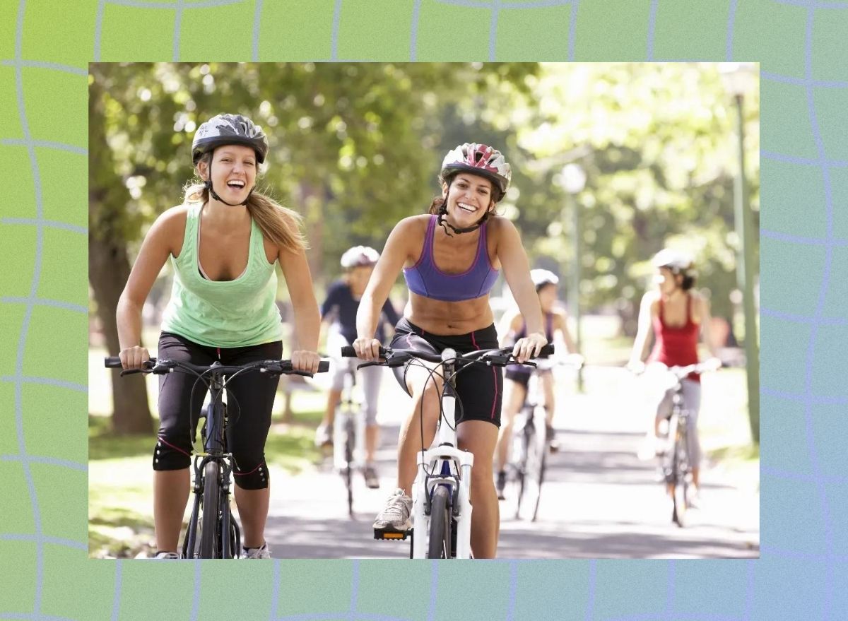 a photo of two women riding bikes in the park on a wavy green and blue designed background