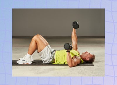 fit, muscular man in lime green tank top and gym shorts doing dumbbell chest press on the floor