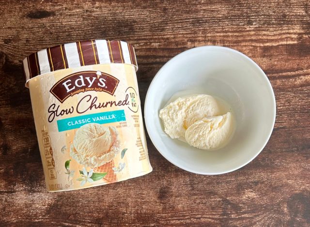 container of edy's slow-churned classic vanilla ice cream next to a bowl of the ice cream