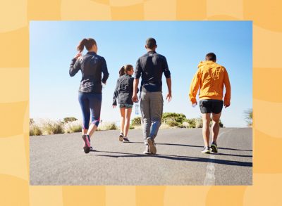 group of friends or fitness group doing a walking workout uphill