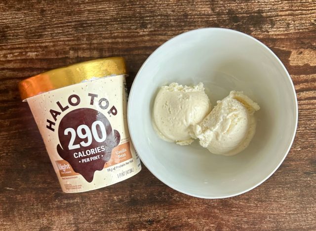 pint of halo top vanilla bean light ice cream next to a bowl of the ice cream