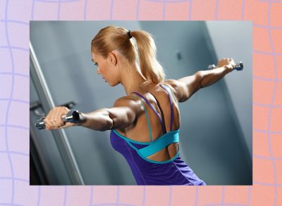 fit woman doing dumbbell lateral raise exercise at the gym