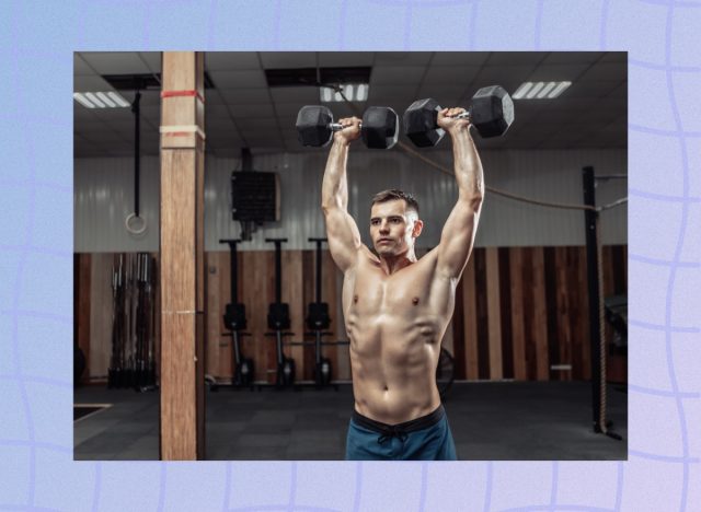 fit, muscular man doing dumbbell overhead shoulder press