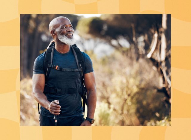 mature man hiking outdoors on grassy trail