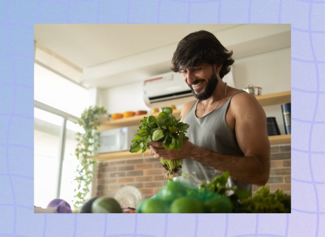 man holding green veggies