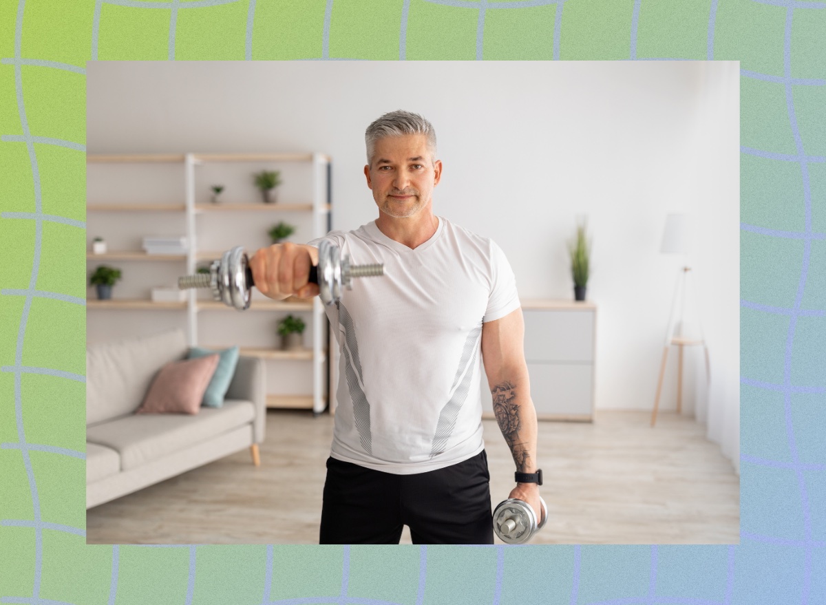 fit, mature man lifting dumbbells in his bright home