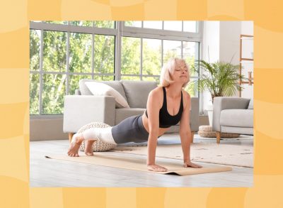 mature woman doing yoga exercise in her bright living space