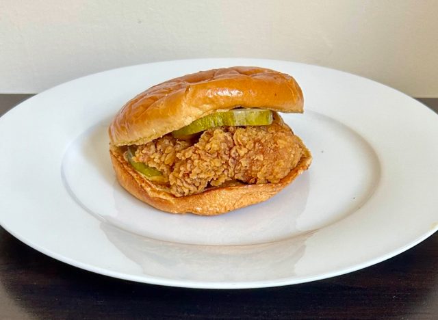 popeyes' golden bbq chicken sandwich on a white plate